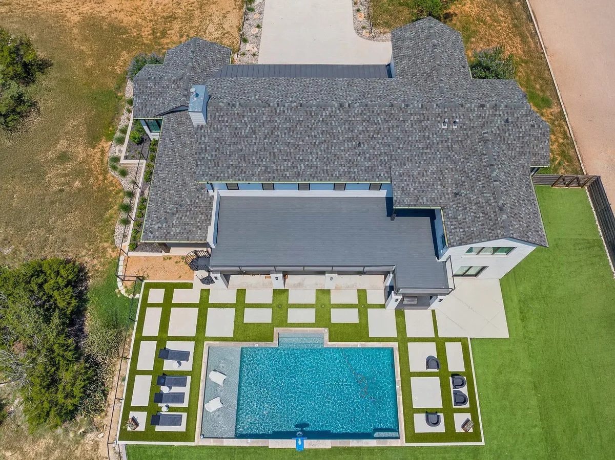 Aerial view of an architectural asphalt shingle roof on a Fort Worth home with pool